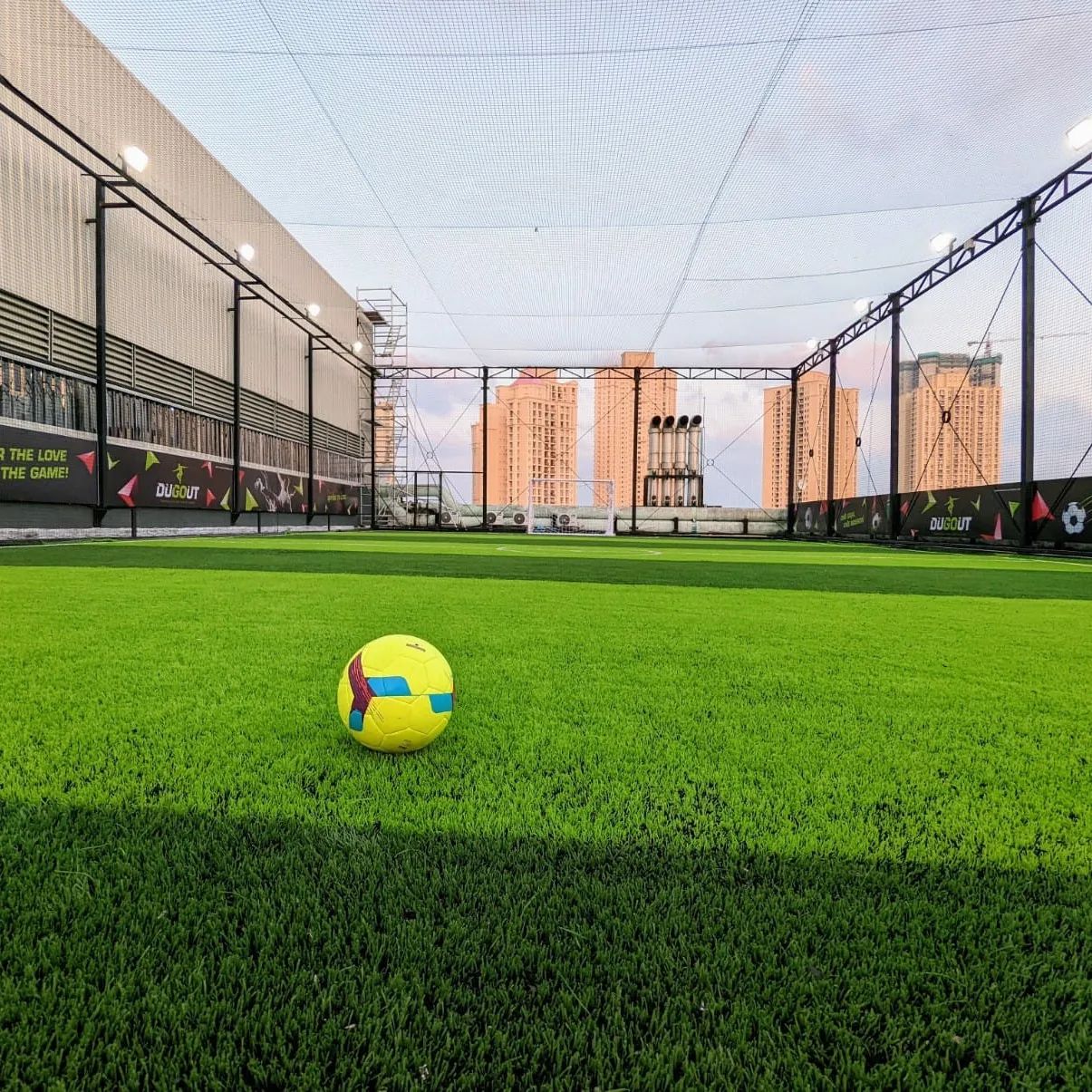 Beautiful view of an indoor futsal turf in Chennai with a football.
