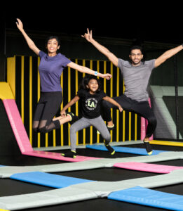 2 adults and a girl having fun at a trampoline park for adults in Chennai.